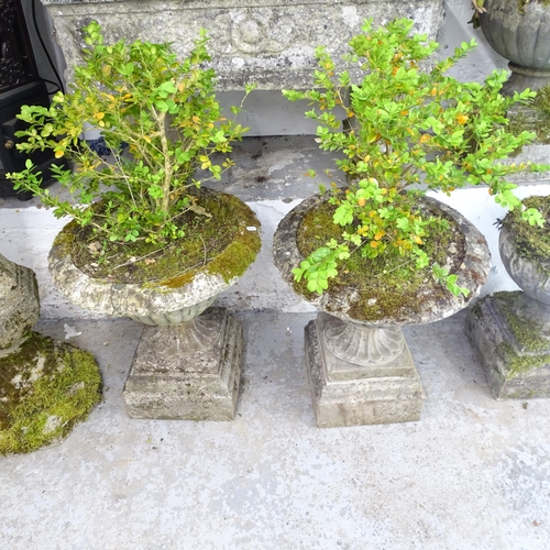 2615 - A pair of three-section weathered concrete campana-style urns. 50x60cm. A/F.