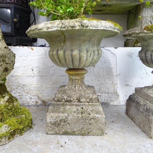 2615 - A pair of three-section weathered concrete campana-style urns. 50x60cm. A/F.