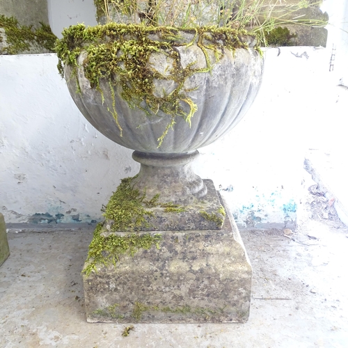 2617 - A pair of weathered concrete two-section garden urns. 38x54cm.
