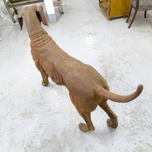 2619 - A large and impressive cast iron garden statue, study of a dog. 135x98x40cm.