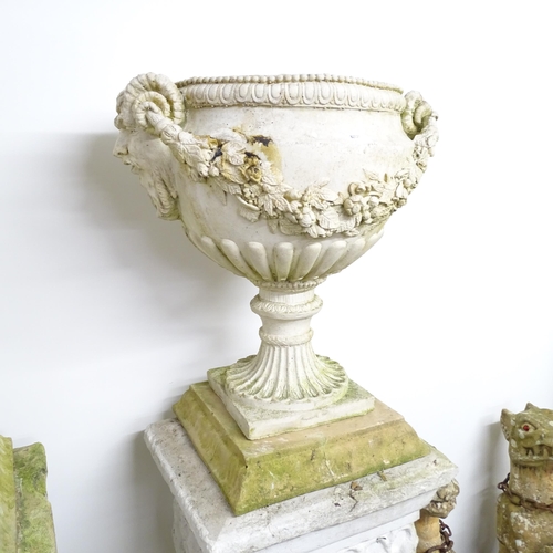 2631 - A weathered concrete two-section garden urn. 50x54x38cm.