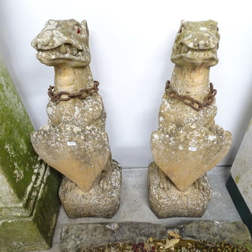 2634 - A pair of weathered concrete gatepost caps in the form of armorial dragons. 26x80x26cm.