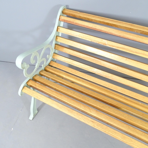 2652 - A teak slatted garden bench with painted metal ends. 137x76x72cm.