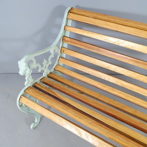 2653 - A teak slatted garden bench with painted metal ends. 127x77x70cm.