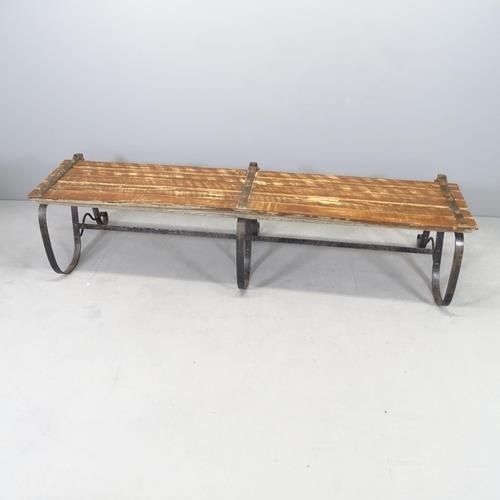 2658 - A folding teak slatted and iron framed garden bench. 180x82x52cm, folded H - 42cm.