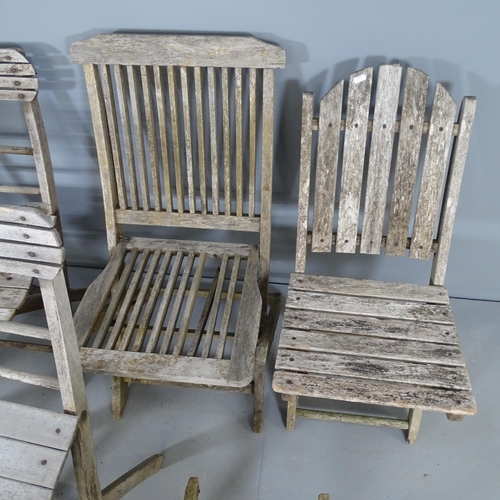 2661 - Seven various teak folding garden chairs.