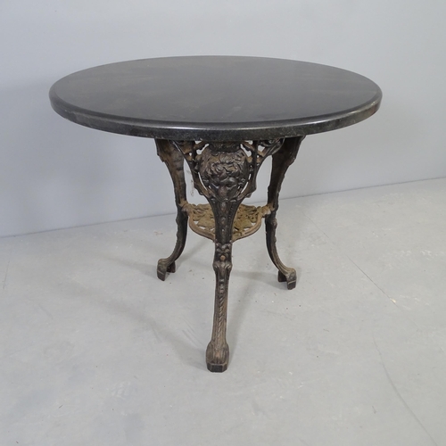 2665 - A circular basalt topped pub table on cast iron base. 75x70cm.