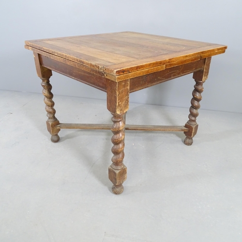 2682 - An early 20th century oak draw-leaf dining table, on barley twist legs with x-shaped stretcher. 91x7... 