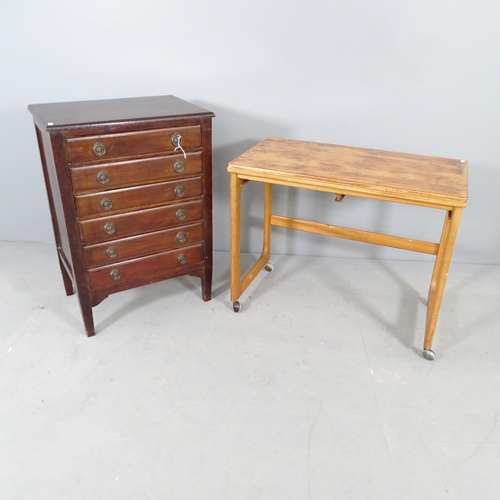 2684 - A mid-century Mcintosh fold-over occasional table, 74x60x40, and a six draw music chest. (2).