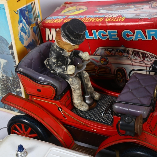 165 - A Vintage Japanese tinplate battery-operated Shakin' Antique car, with driver, unboxed, and 2 simila... 