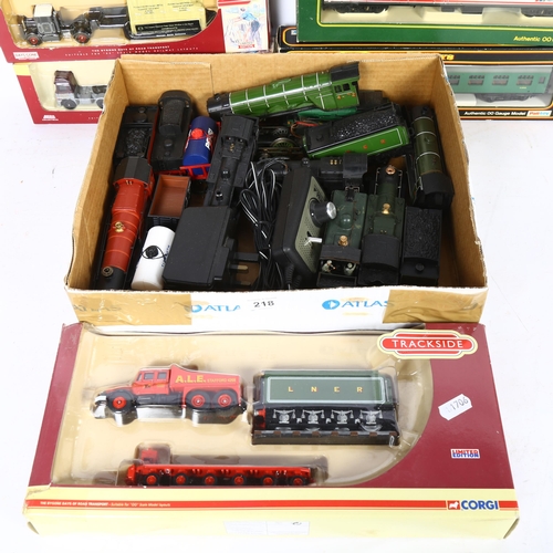 218 - A group of OO gauge locomotives, tenders, and associated goods wagons, some loose and some boxed, in... 