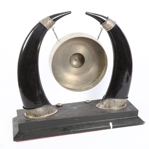 275 - An Antique horn and white metal-mounted dinner gong, on painted stepped base, H42cm, W47cm (no hamme... 