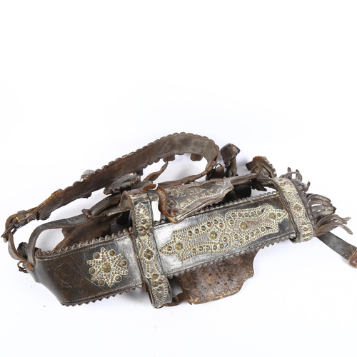 276 - An impressive Victorian leather and studded brass decorated horse's halter, with bells, L65cm approx