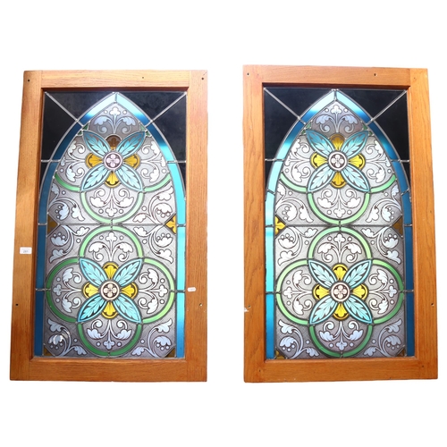 281 - A pair of arch-top stained glass leadlight panels, acanthus leaf decoration, in modern oak frames, 1... 