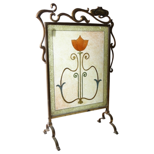282 - An Art Nouveau brass-framed fire screen with an inset stylised glass panel, bead and wirework decora... 