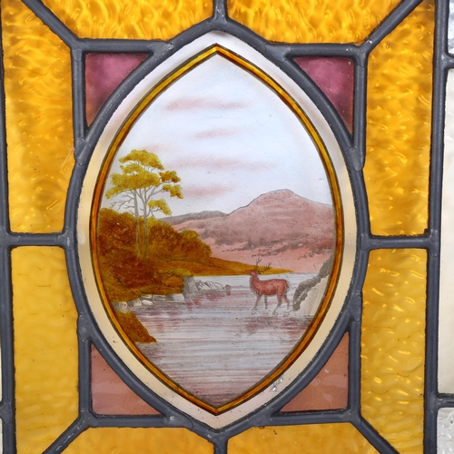 283 - A stained glass leadlight window panel (unframed), hte stag decorated central oval panel flanked by ... 
