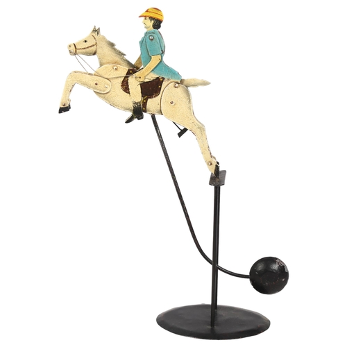 299 - An early 20th century painted balance polo player, metal and lead, the rider having articulated arms... 