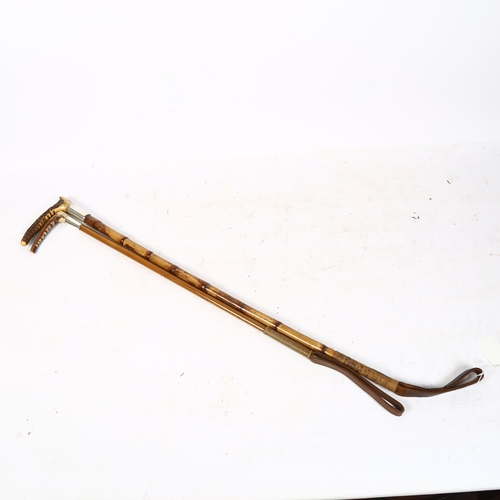 310 - 2 horn-handled riding crops, 1 having a faux bamboo cane and silver mount, initialled A.M.C. Novembe... 