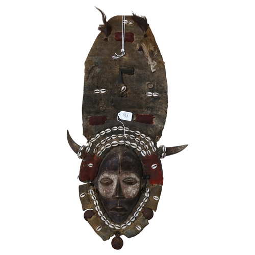 323 - An unusual Tribal mask, with shell and horn decoration, L87cm