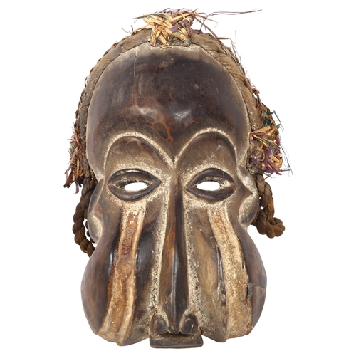 325 - A carved African mask, with rope twist and basketweave decoration, L33cm