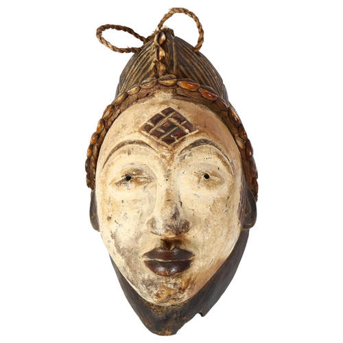 326 - A Puno-Lumbo design Tribal mask, carved decoration and shell banding, in white and black, L30cm