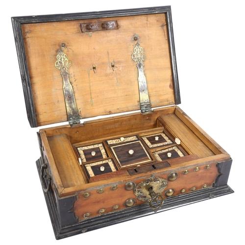 342 - A 19th century walnut and ebony travelling box, studded brass mounted, with fitted interior, with br... 