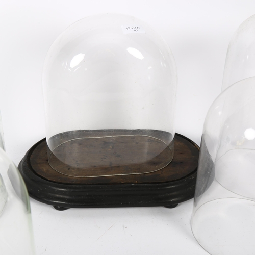 366 - A group of 6 various glass domes, and an oval dome stand but no dome for this, tallest 37cm