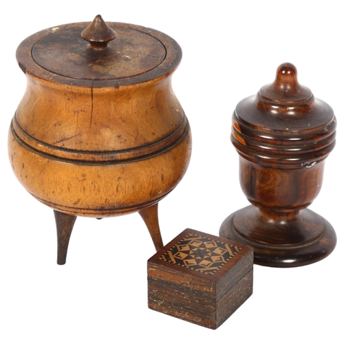 464 - A turned wood treen spool holder and cover, and a turned wood caldron and cover on 3 splayed legs, t... 