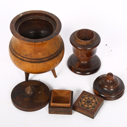 464 - A turned wood treen spool holder and cover, and a turned wood caldron and cover on 3 splayed legs, t... 