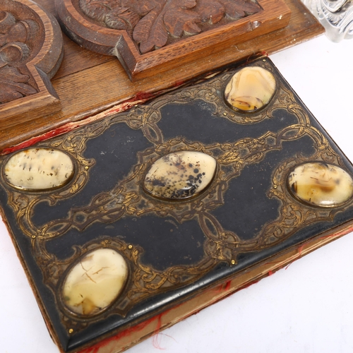 509 - A Victorian carved oak extending book rack, a Victorian papier mache gilded desk blotter, with appli... 