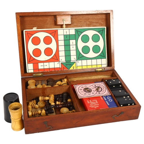 525 - A mahogany boxed games compendium, including dominos, draughts, and chess set etc