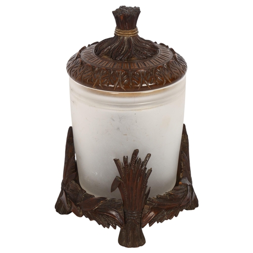 531 - A Black Forest design biscuit barrel, with acanthus leaf carved lid and wheatsheaf knop, sitting in ... 