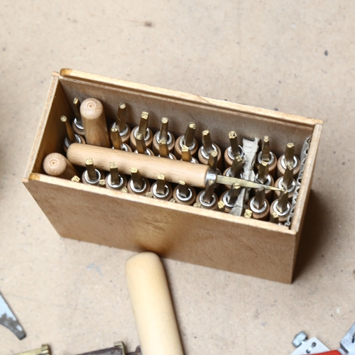 551 - A collection of brass and other mounted book-binding tools, including typesetting tools (3 boxes)