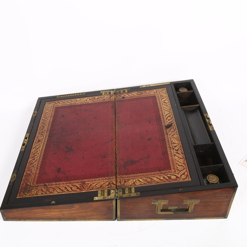 579 - A Victorian rosewood and brass-bound travelling writing slope, with associated inkwells, L46cm, H15c... 