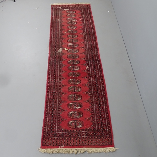 2313 - A red-ground Bokhara runner. 280x80cm