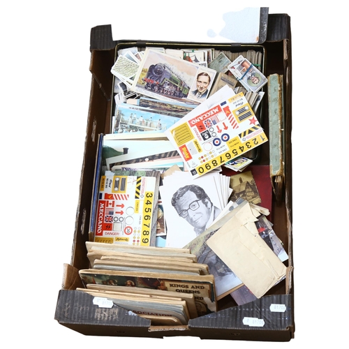 822 - A boxful of cigarette card albums, postcards, snapshots, tin etc