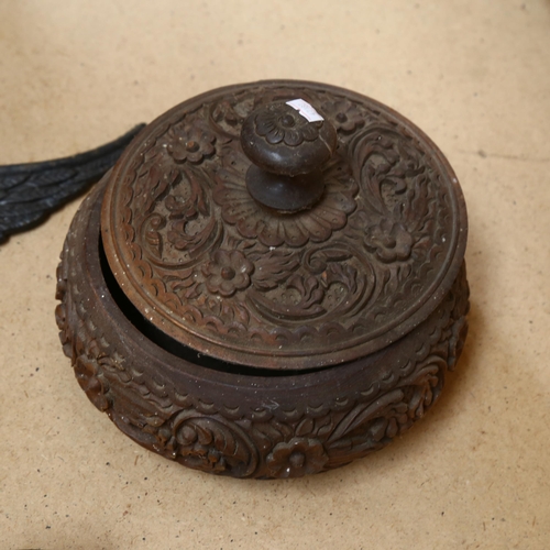 826 - A carved wood box, a Tribal mask, 62cm, a carved pediment, a copper jug, and a cast-iron eagle