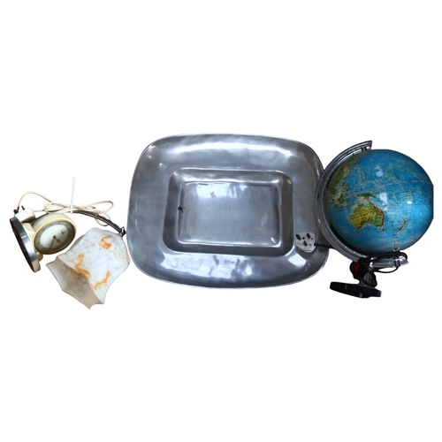 887 - A Mexican aluminium serving dish, 52cm, an illuminated globe, and a Vintage alarm clock table light