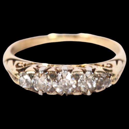 1219 - An unmarked gold diamond set five stone dress ring, size M