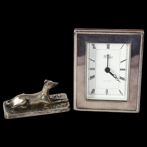 1222 - R CARR - a silver-fronted quartz mantel clock, and a silver plated Greyhound design paperweight