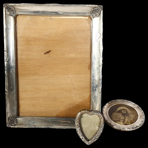 1223 - A rectangular silver-fronted photo frame, a heart-shaped silver-fronted photo frame, and a circular-... 