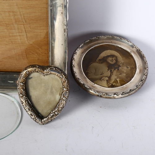 1223 - A rectangular silver-fronted photo frame, a heart-shaped silver-fronted photo frame, and a circular-... 