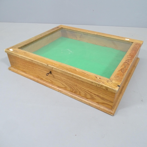 2281 - An oak and glass table-top display cabinet. 66x14x56cm.