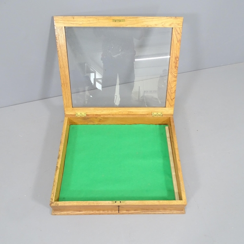 2281 - An oak and glass table-top display cabinet. 66x14x56cm.