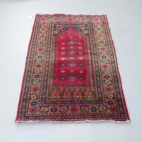 2310 - A red-ground Persian prayer rug. 135x90cm.