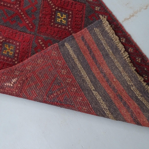 2321 - A red ground Meshwani runner. 252x57cm.