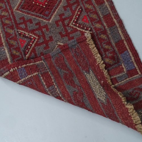 2323 - A red-ground Meshwani runner. 248x53cm