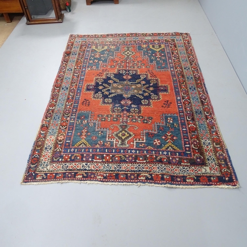 2325 - A red-ground Persian design rug. 198x140cm.