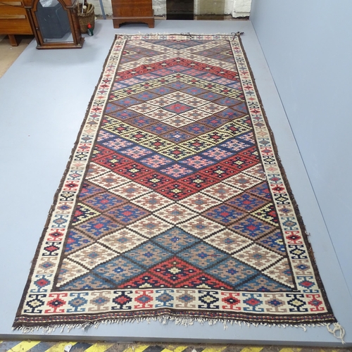 2326 - An antique Kilim rug. 312x140cm.