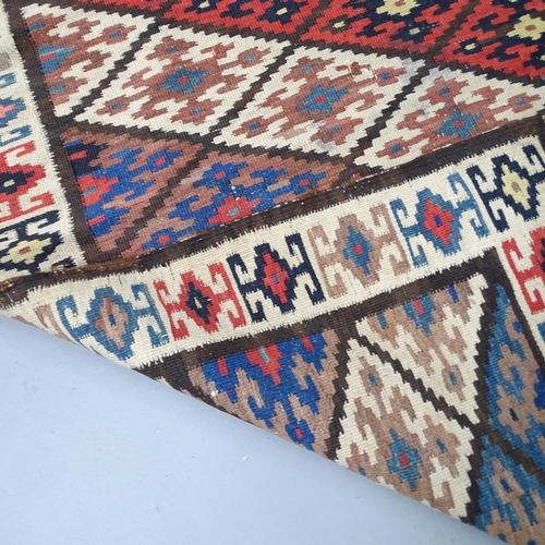 2326 - An antique Kilim rug. 312x140cm.